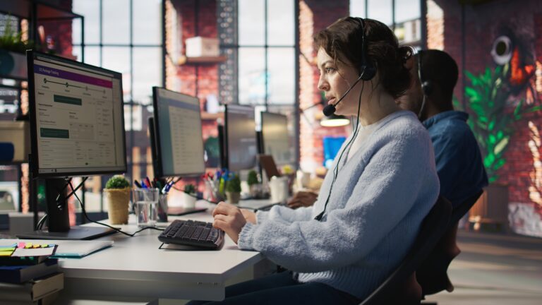 Call centre team wearing headsets helping customers