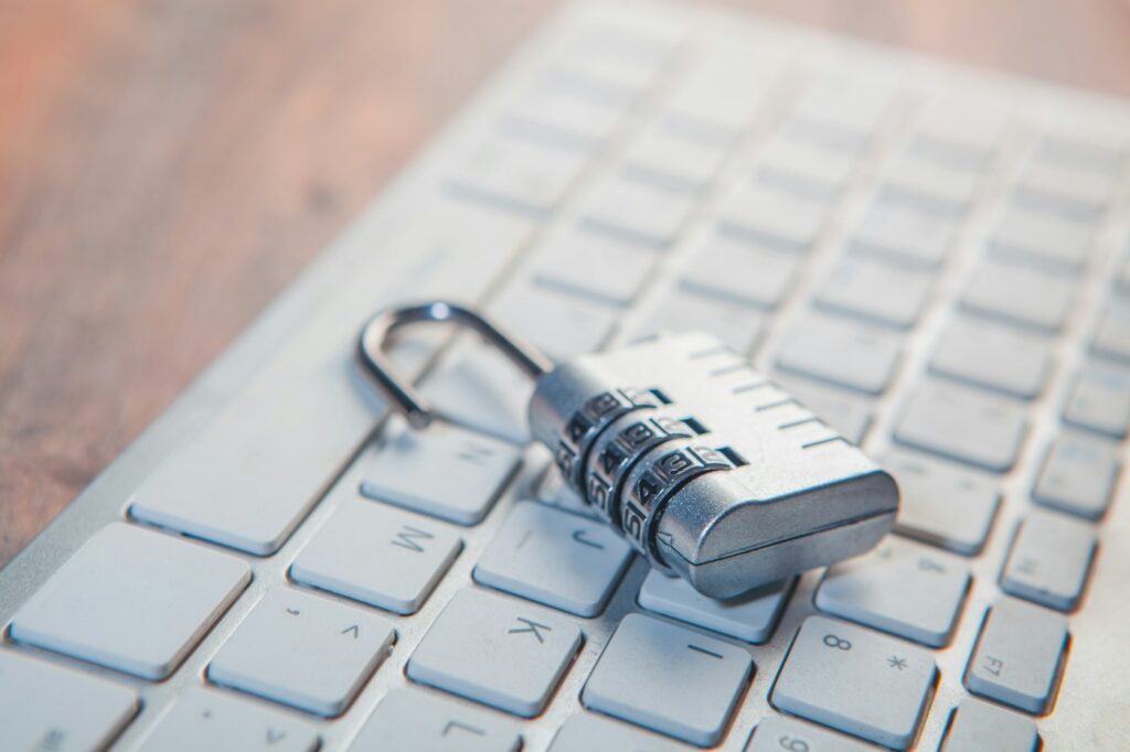 Combination padlock resting on a laptop keyboard