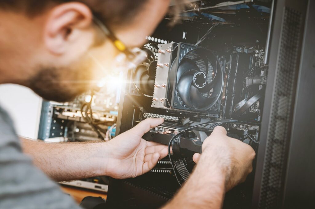 Technician installing hardware in a desktop computer