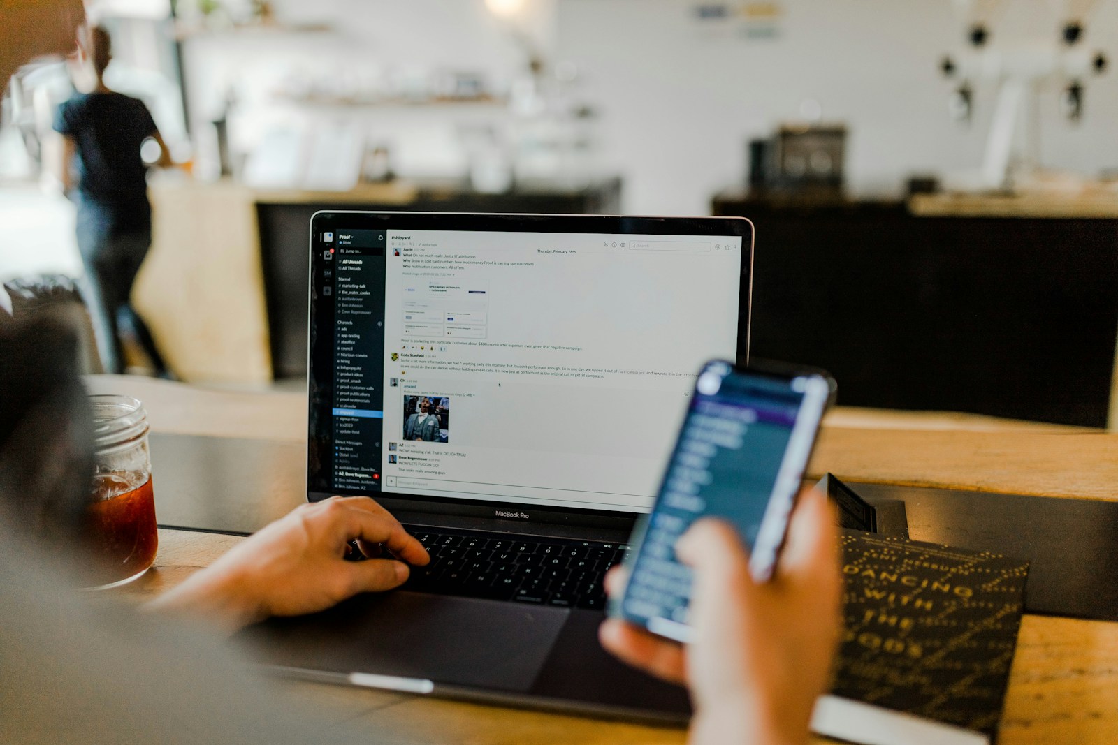 Person using a laptop and smartphone together